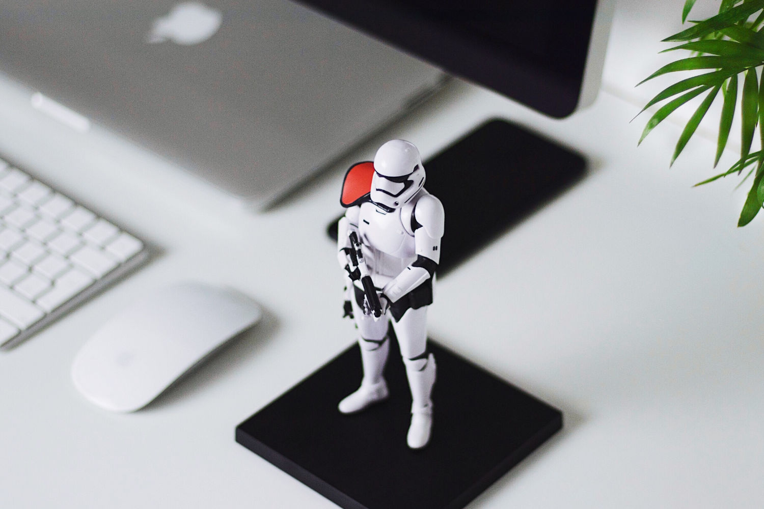 Toy stormtrooper next to laptop