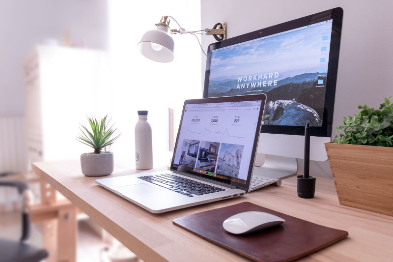 Mac laptop and iMac on a desk