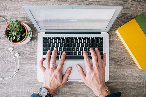 Hands typing on a keyboard