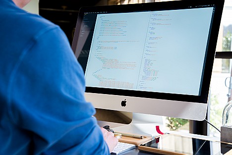 iMac screen with website code