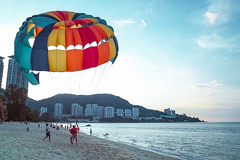 Paraglider landing on a beach