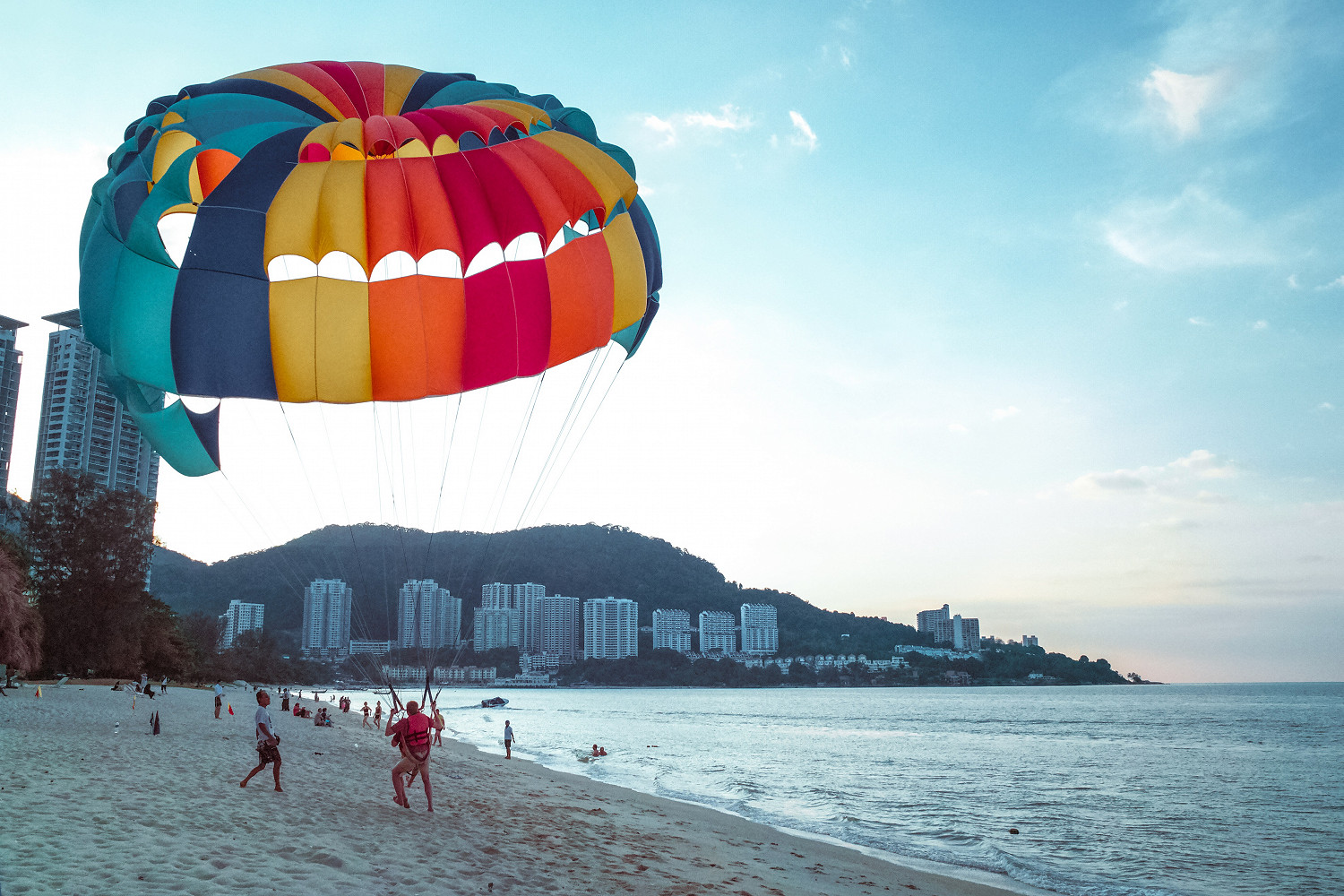 Paraglider landing on a beach