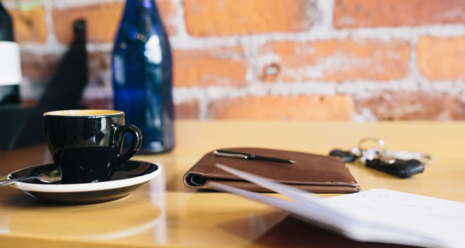 Coffee cup and notebook